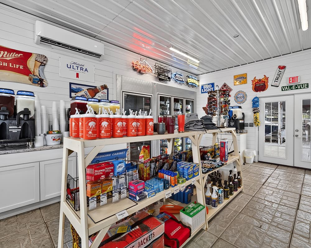 Interior of a convenience store featuring shelves of snacks, drinks, and various merchandise.