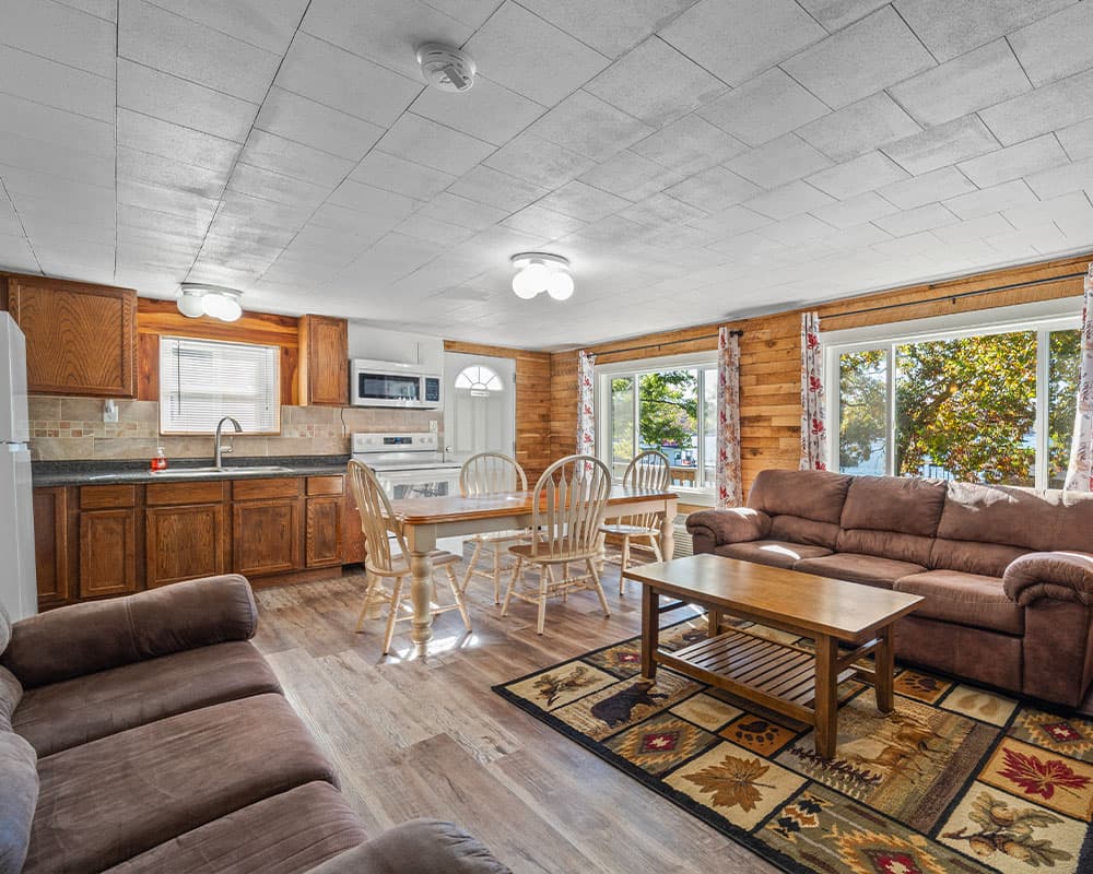 Cozy open-concept living area with a kitchen, dining table, and comfortable seating.